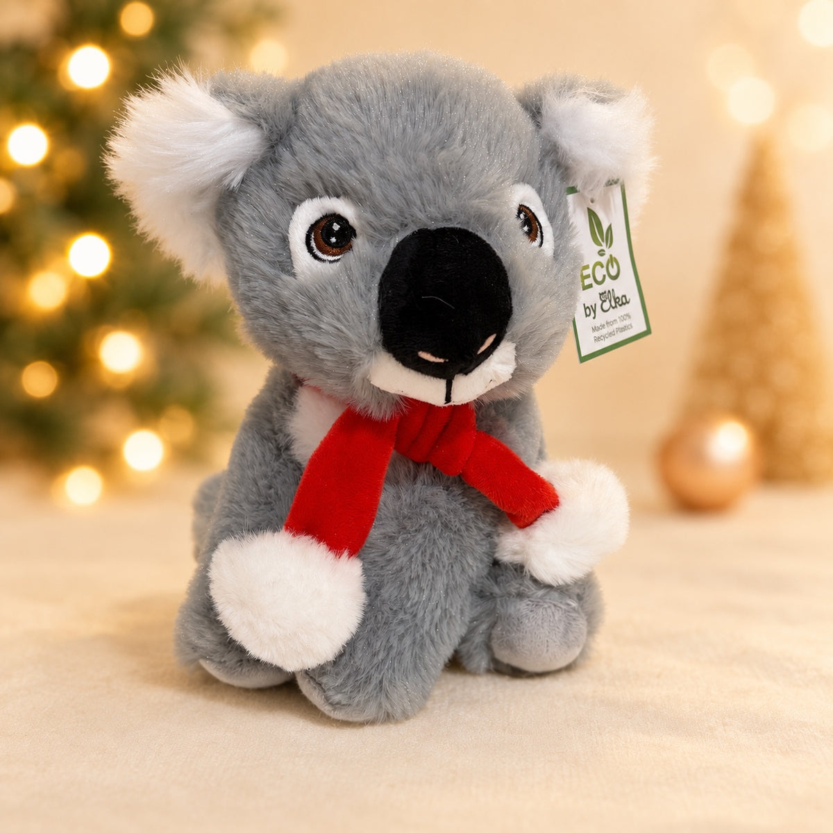 Grey koala plush with a red scarf, front view, on a Christmas setting